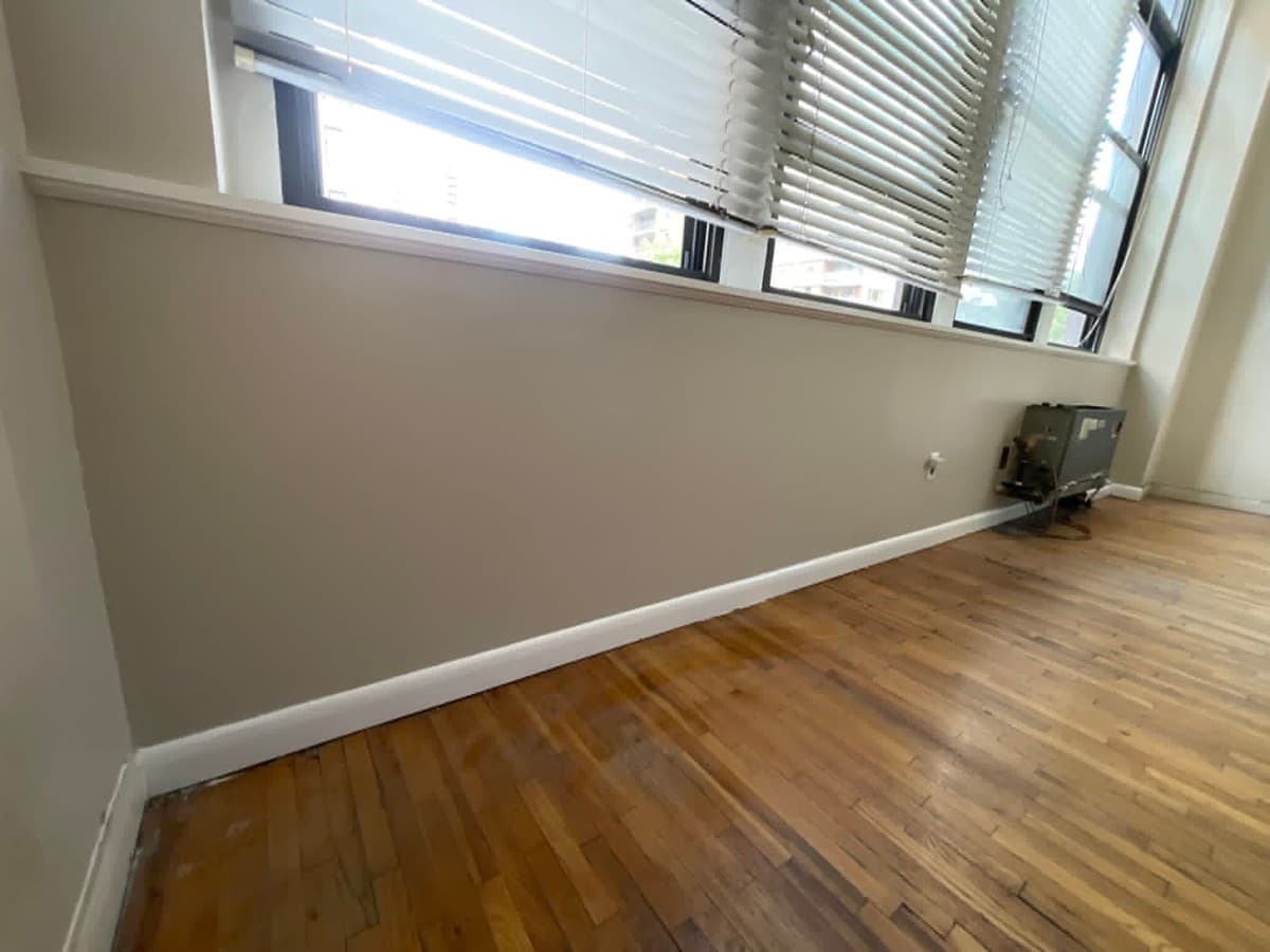 Finished interior room with painted walls, trim and wood flooring