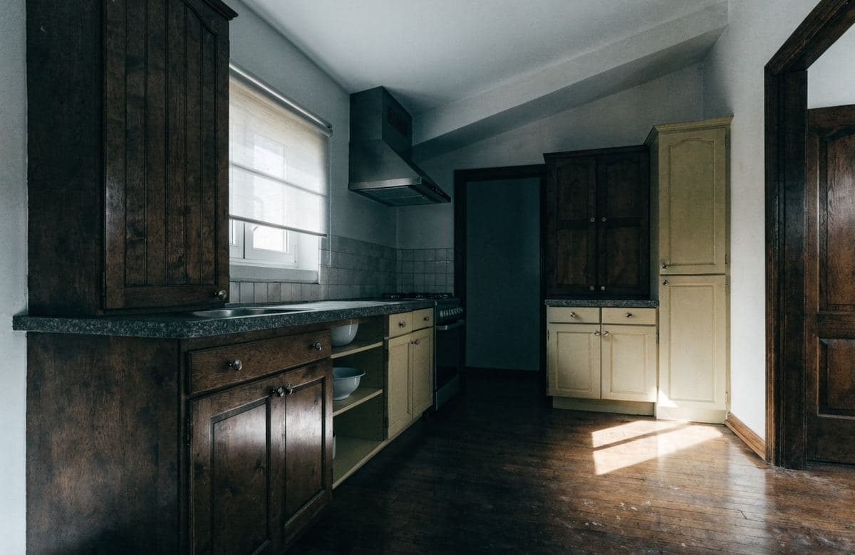 Illustrative awkward outdated kitchen with mismatched cabinets