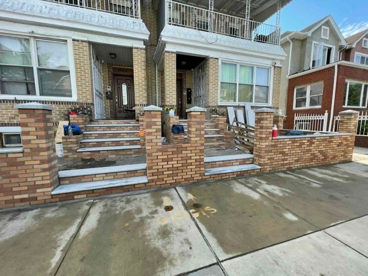 Completed brick steps and masonry work at a residential entrance