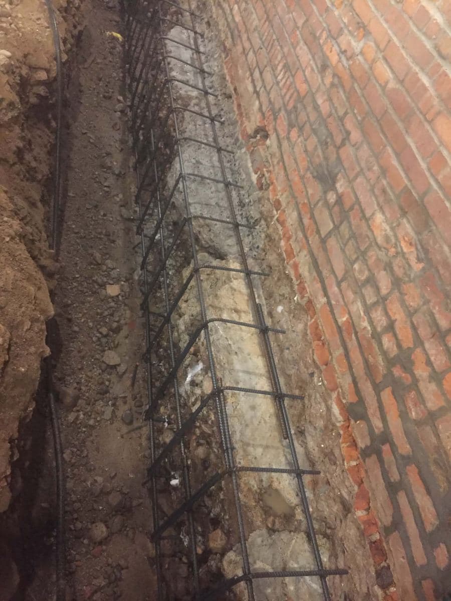 Long brick facade wall along a property