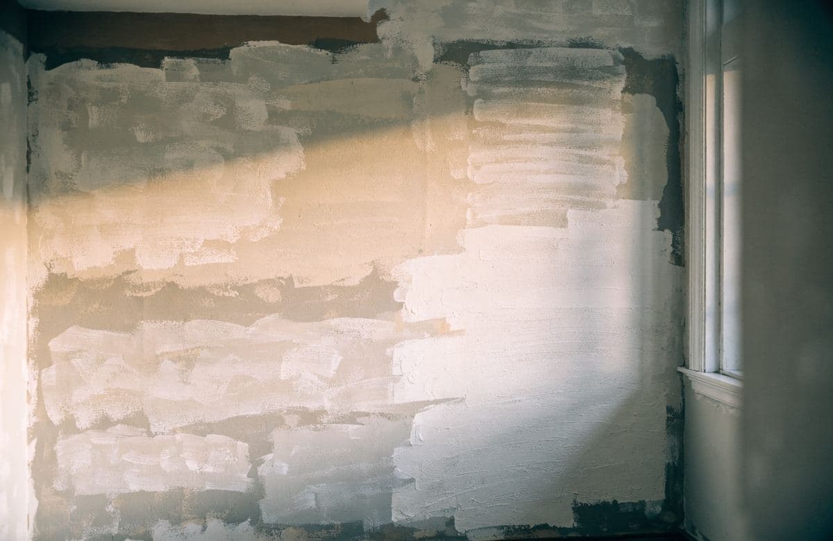 Illustrative interior wall with uneven, patchy previous paint coats