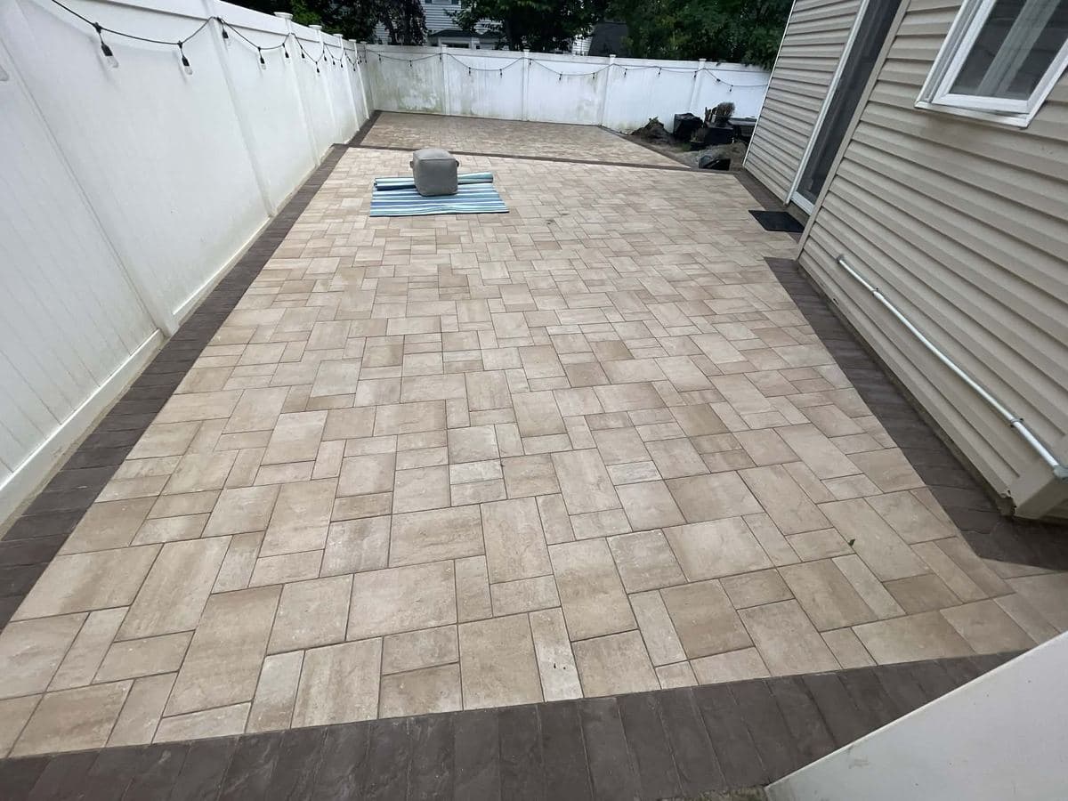 Finished paver patio with tight joints and a dark border