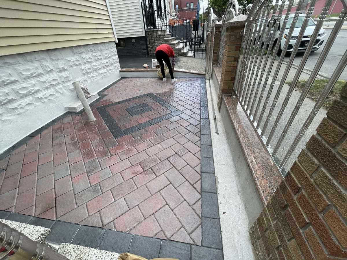 Paver surface with contrasting border courses being finished