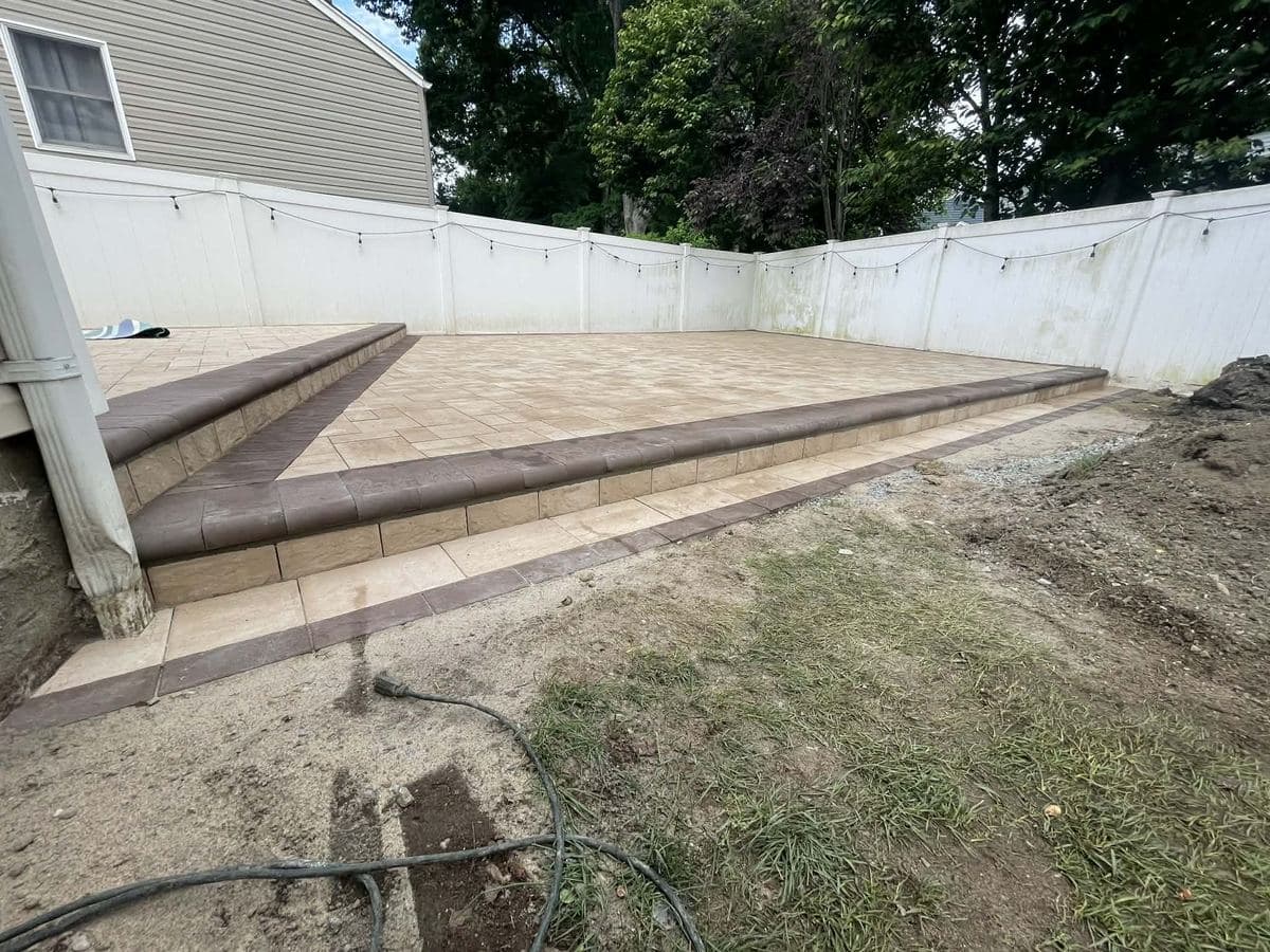 Raised border course holding the edge of a new paver field