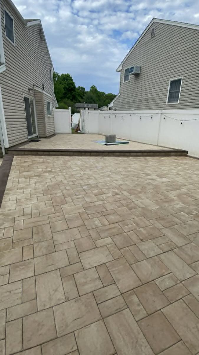 Large-format paver surface installed across a residential outdoor area