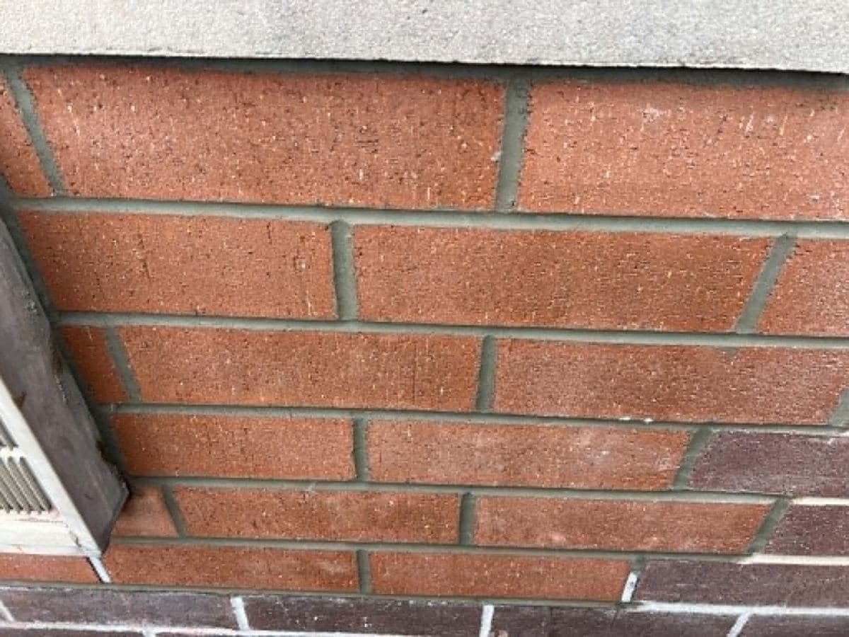 Close view of brick courses with newly filled and tooled mortar joints