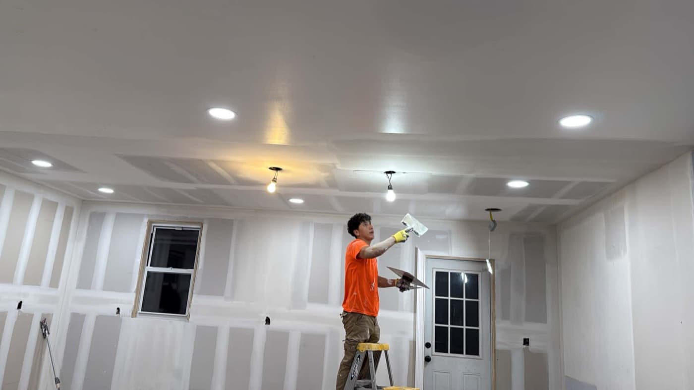 Construction professional finishing drywall during an interior project
